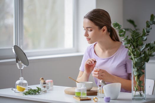 A young woman embraces self-care with natural cosmetics indoors.