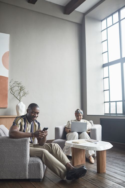 Free Two colleagues working in a stylish office with tech devices and modern design. Stock Photo