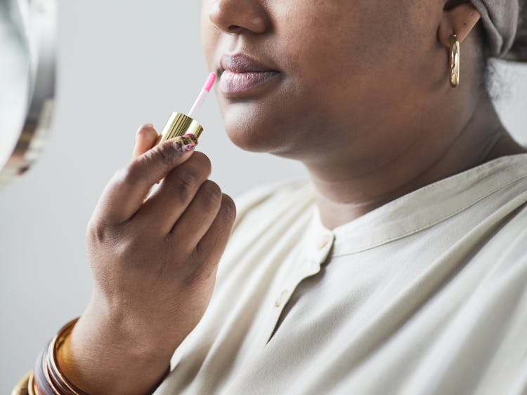 Close-Up Shot Of A Person Putting On Lipstick