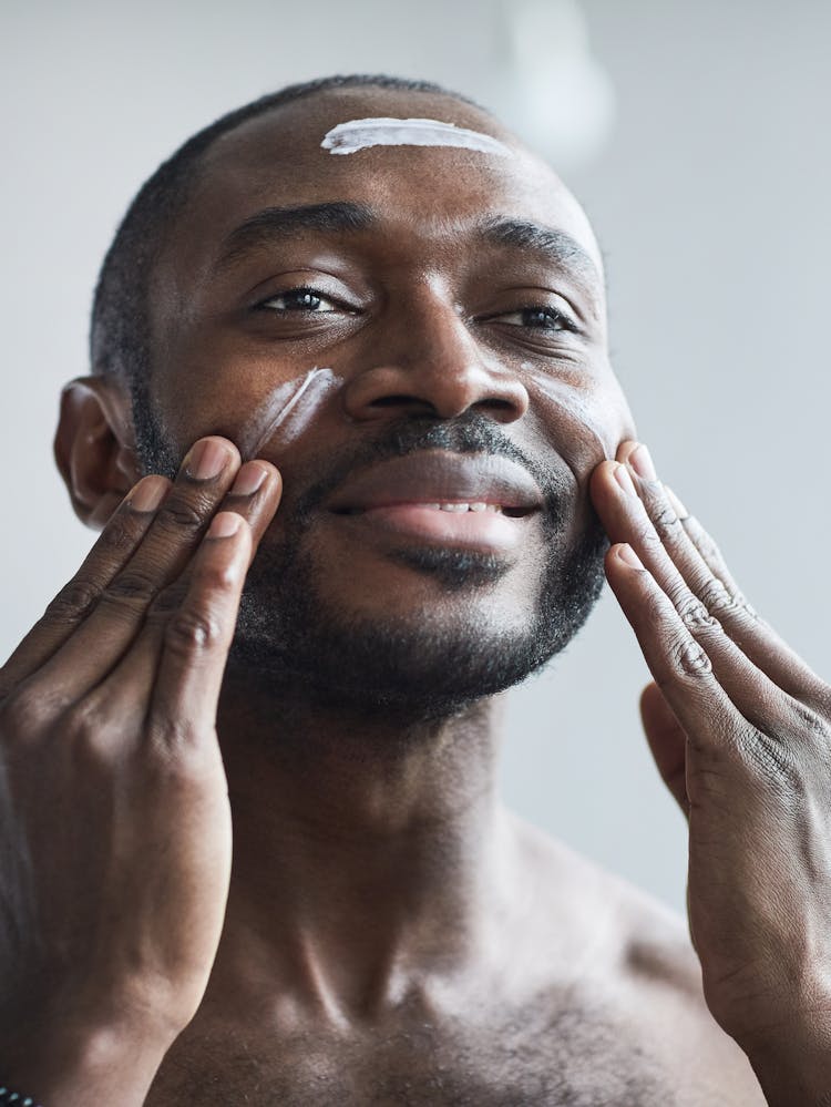 Man Putting On Face Cream