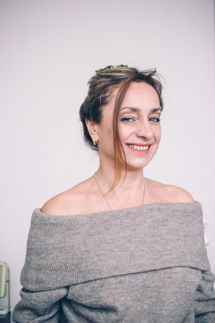 A Woman Wearing An Off Shoulder Sweater