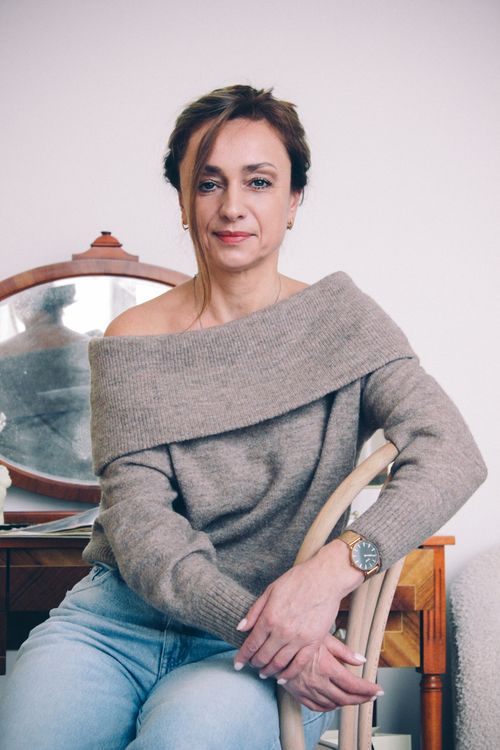 Woman in Gray Sweater Sitting on a Chair · Free Stock Photo
