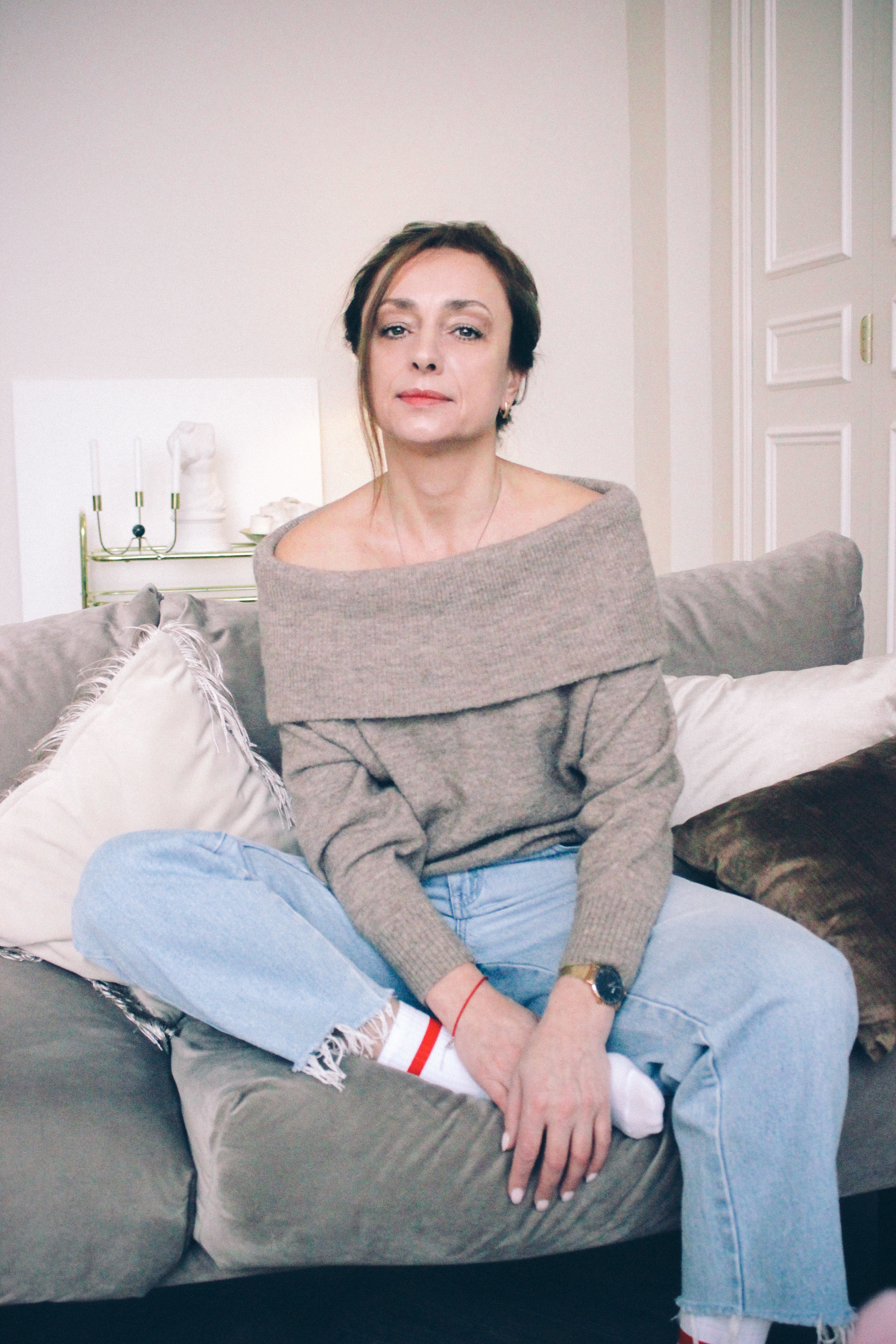 Casual portrait of a woman in denim jeans relaxing at home. Perfect for lifestyle themed projects.