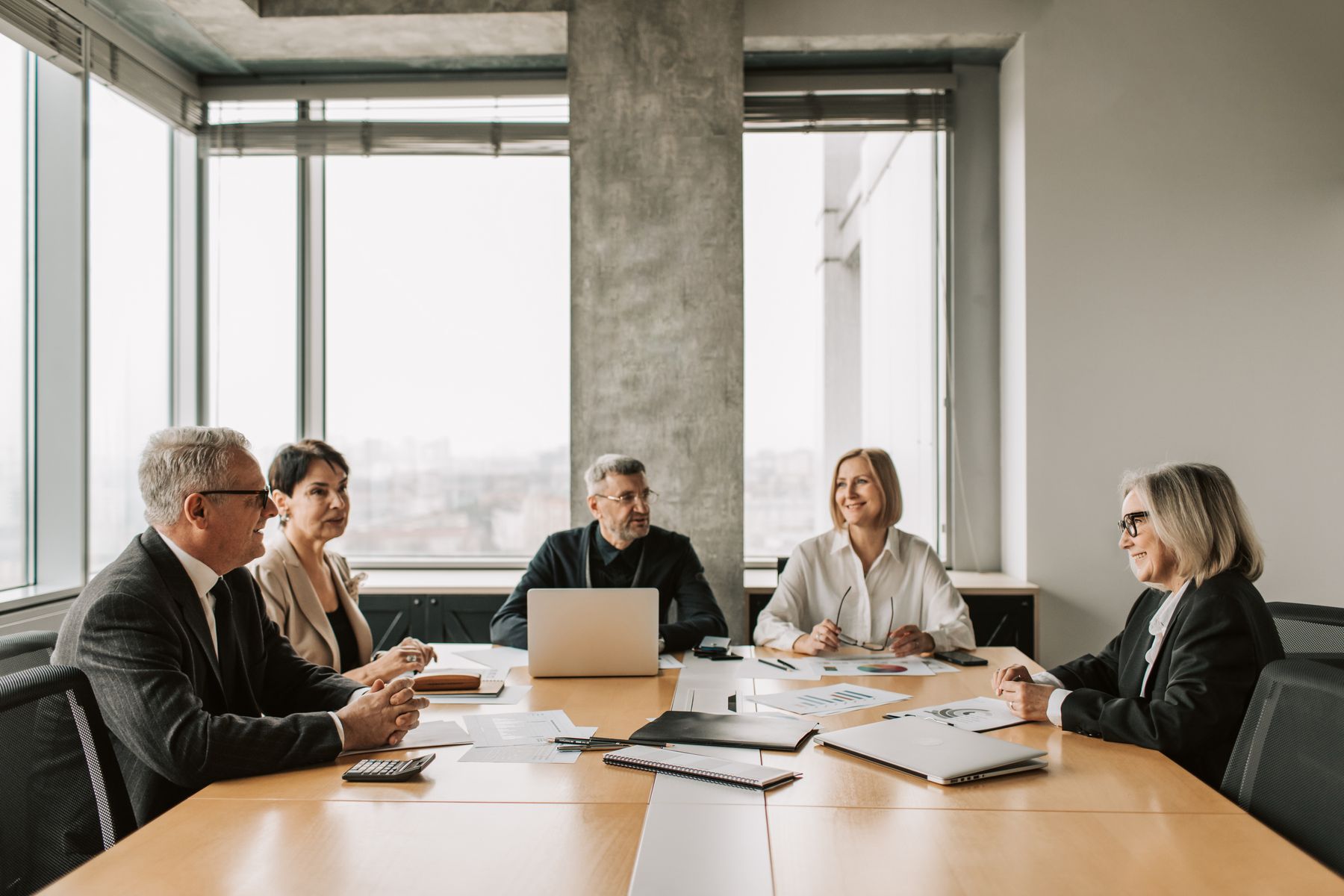Senior professionals taking part in a boardroom discussion
