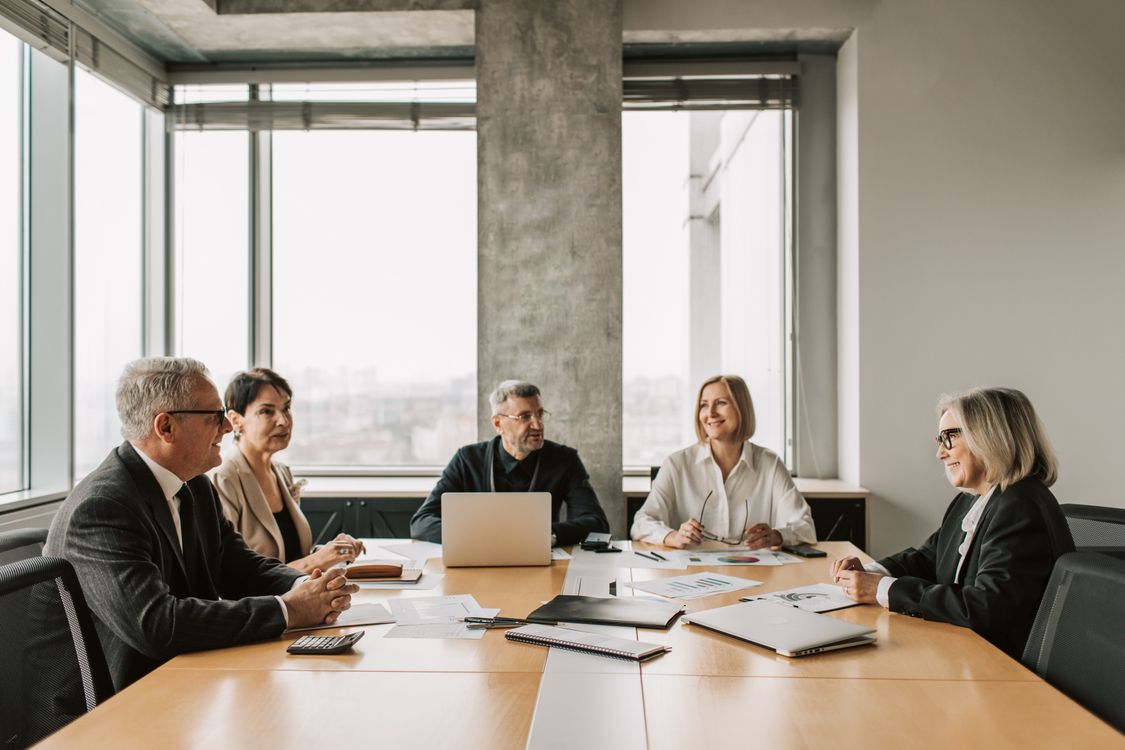 Five business professionals meeting in a bright office