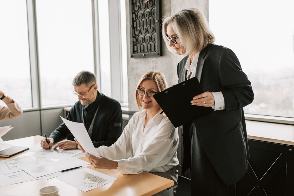 Photo by Vlada Karpovich on Pexels Team of business professionals collaborating in a modern office setting. Engaged in discussion and document review.