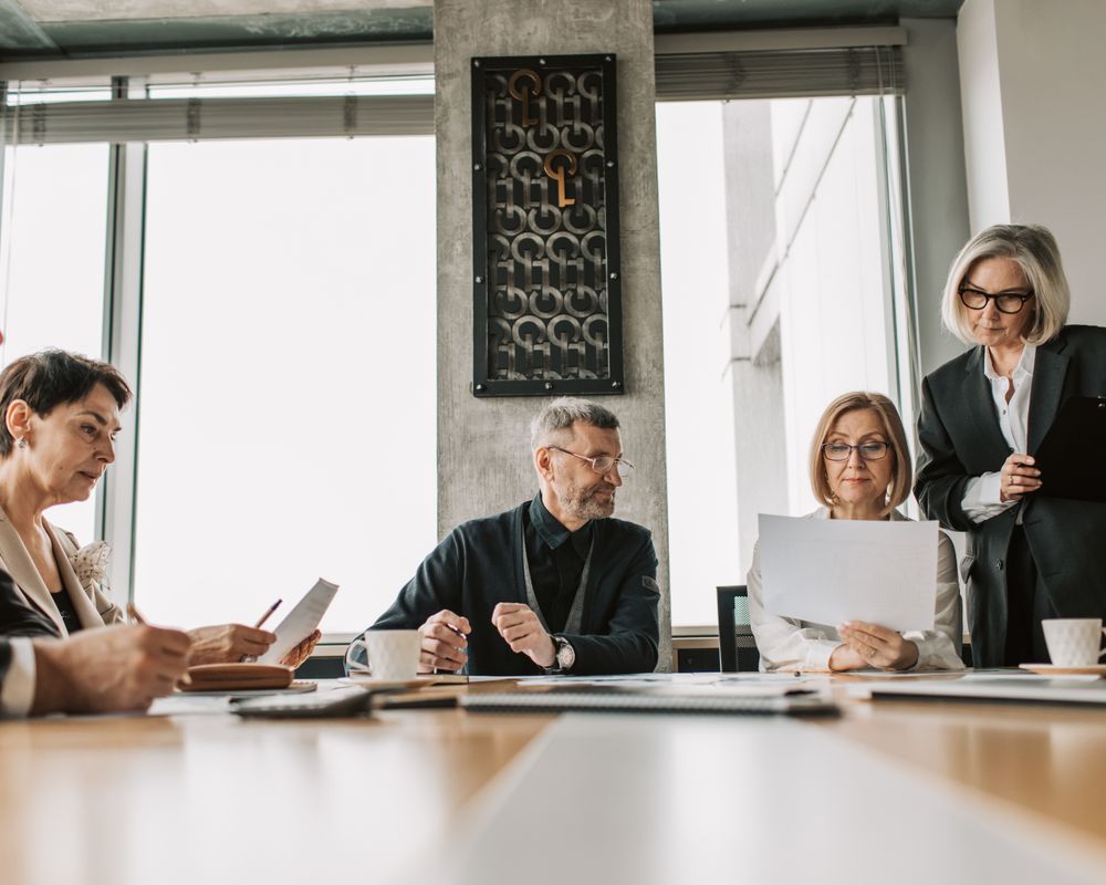 Business professionals discussing documents in a modern meeting room