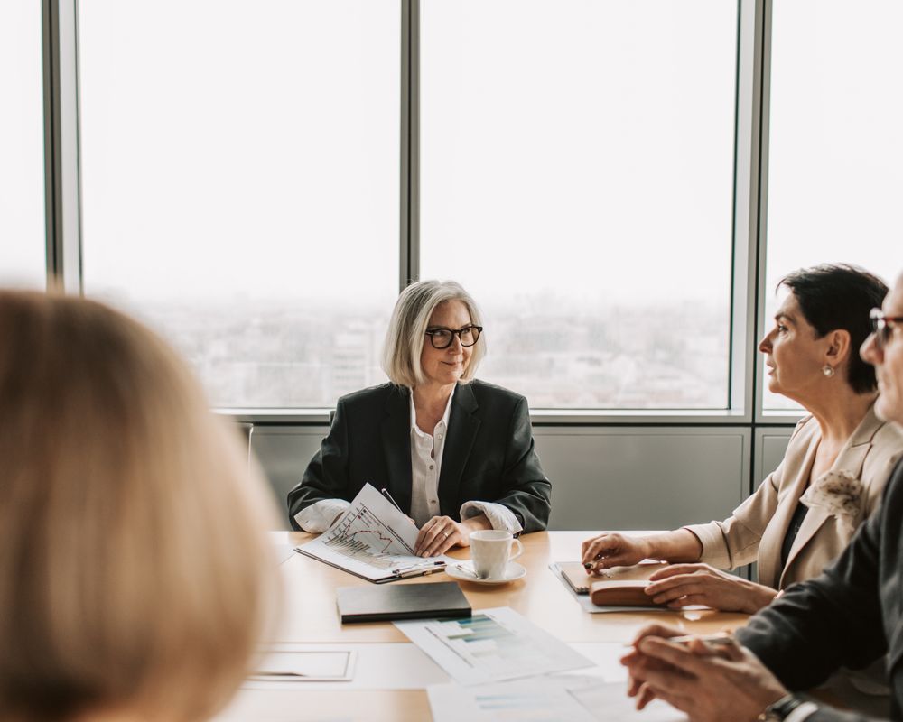 Professionals engaged in a business meeting inside a modern boardroom