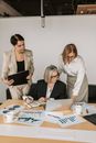 Woman in White Blazer Holding Black Laptop Computer