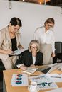Woman in White Blazer Holding White Tablet Computer Beside Woman in White Blazer