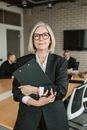 Woman in Black Blazer Holding Black Paper