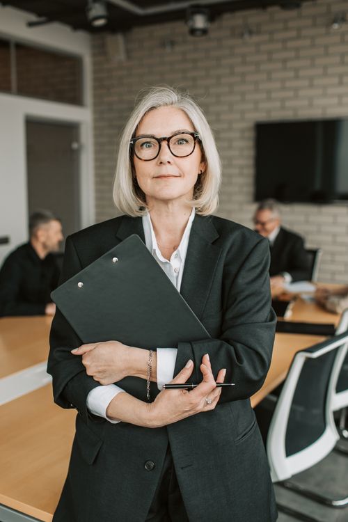 Professional woman in a double-breasted crepe suit at the office