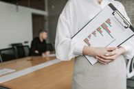 Person in White Long Sleeve Shirt Holding White Paper