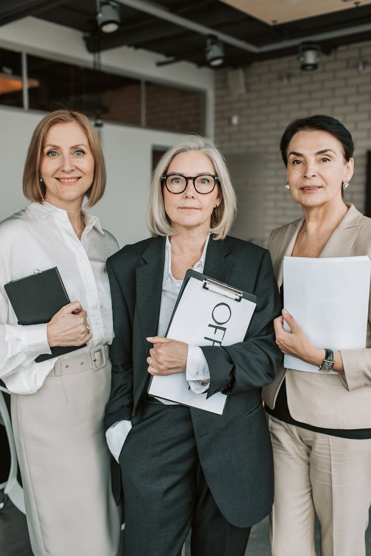 A Group Of Mature Women In Office Attires