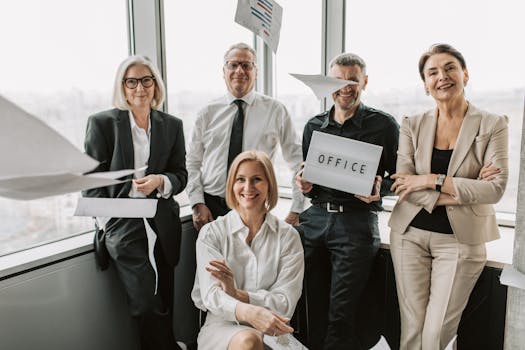 Group of business professionals celebrating achievements inside a modern office space.