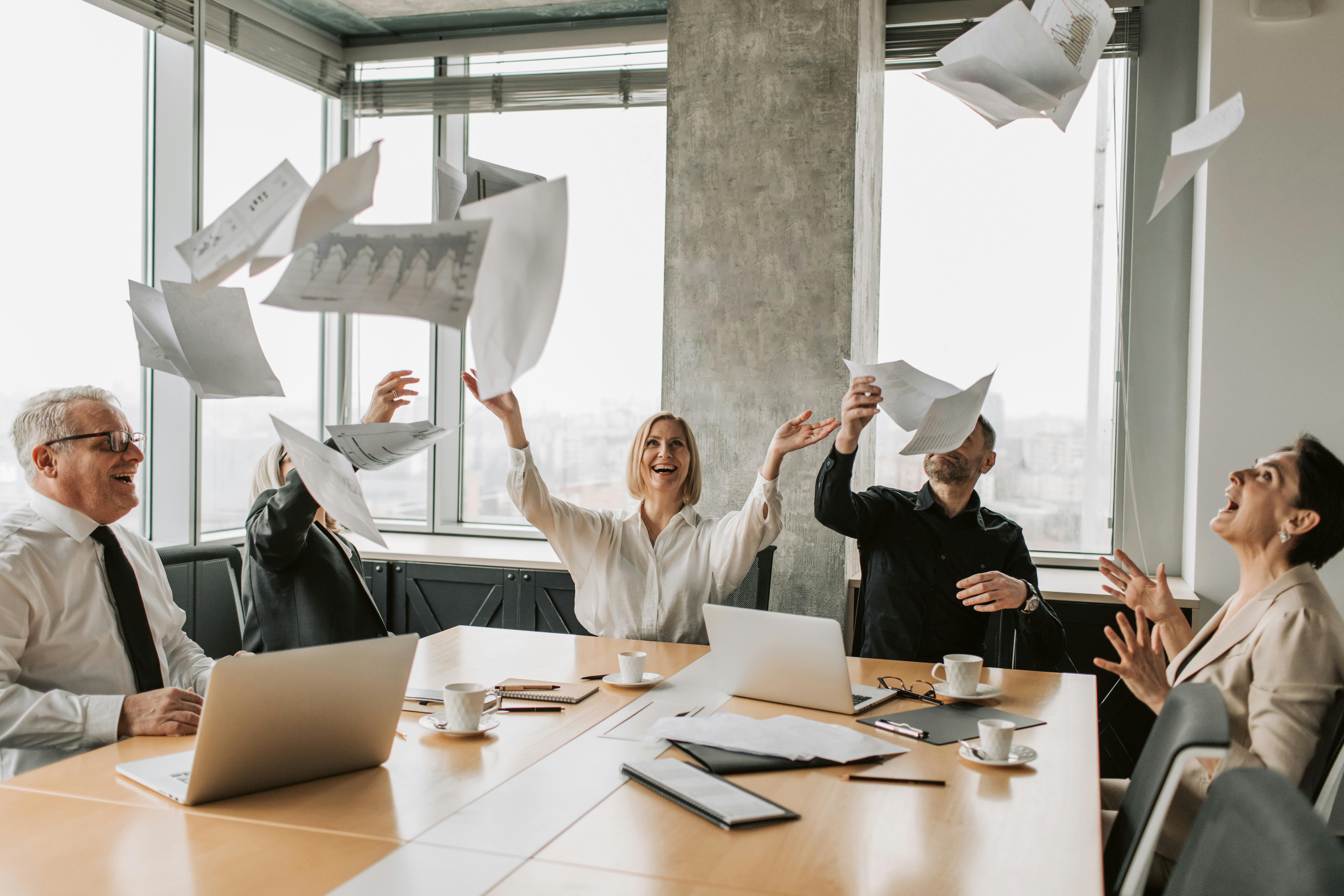 a team throwing papers in the air