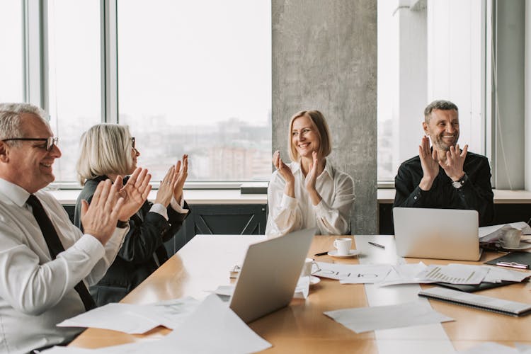 Photo Of Adults Clapping While Smiling