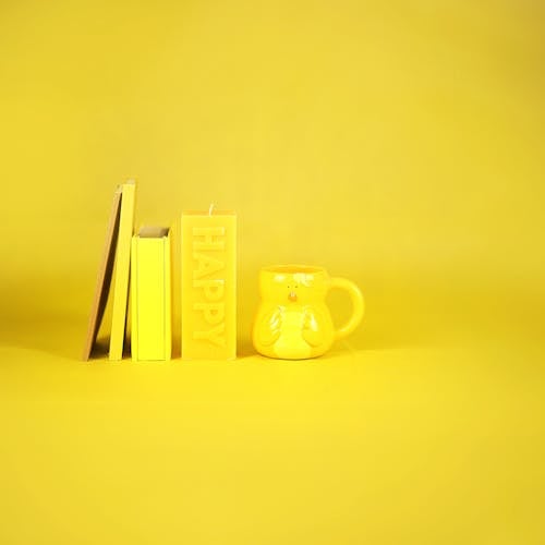 Free Yellow mug and stationery composition Stock Photo
