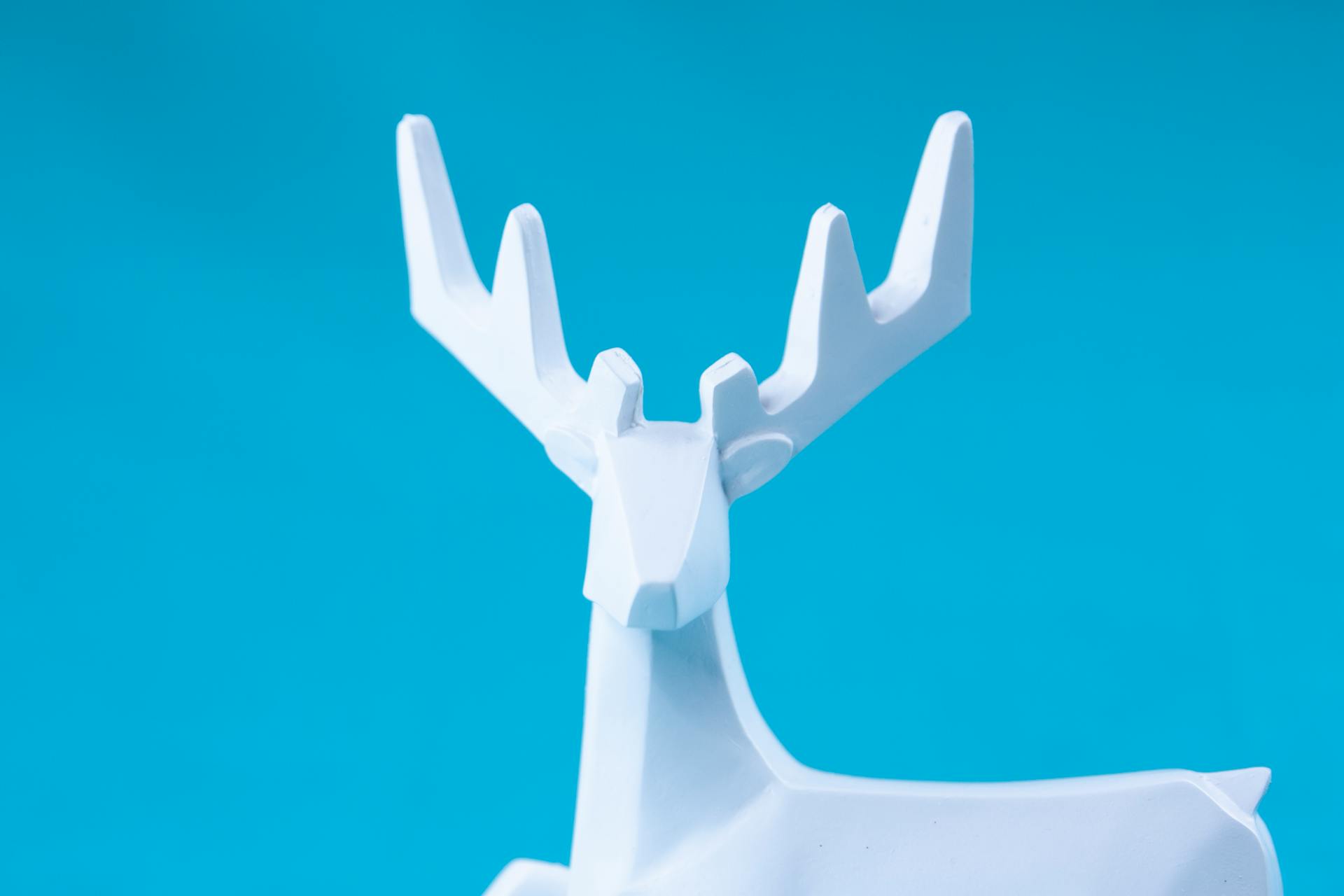 White deer statuette with antlers