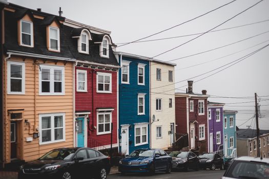 Typical colorful houses near road with cars