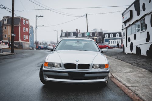 Car parked on road among buildings