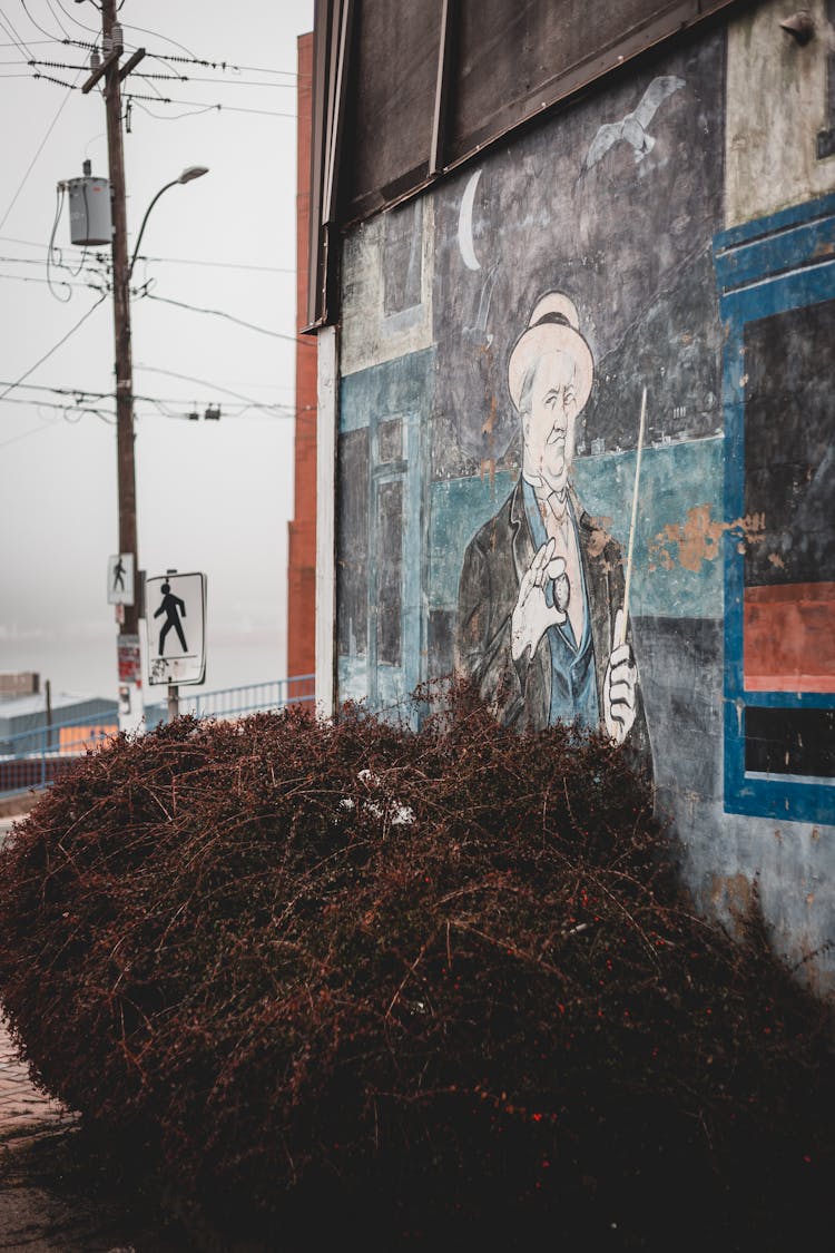 Painting Of Man On Shabby Building