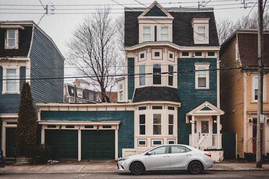 Exterior of aged colorful houses with attics and small windows with car parked on pavement