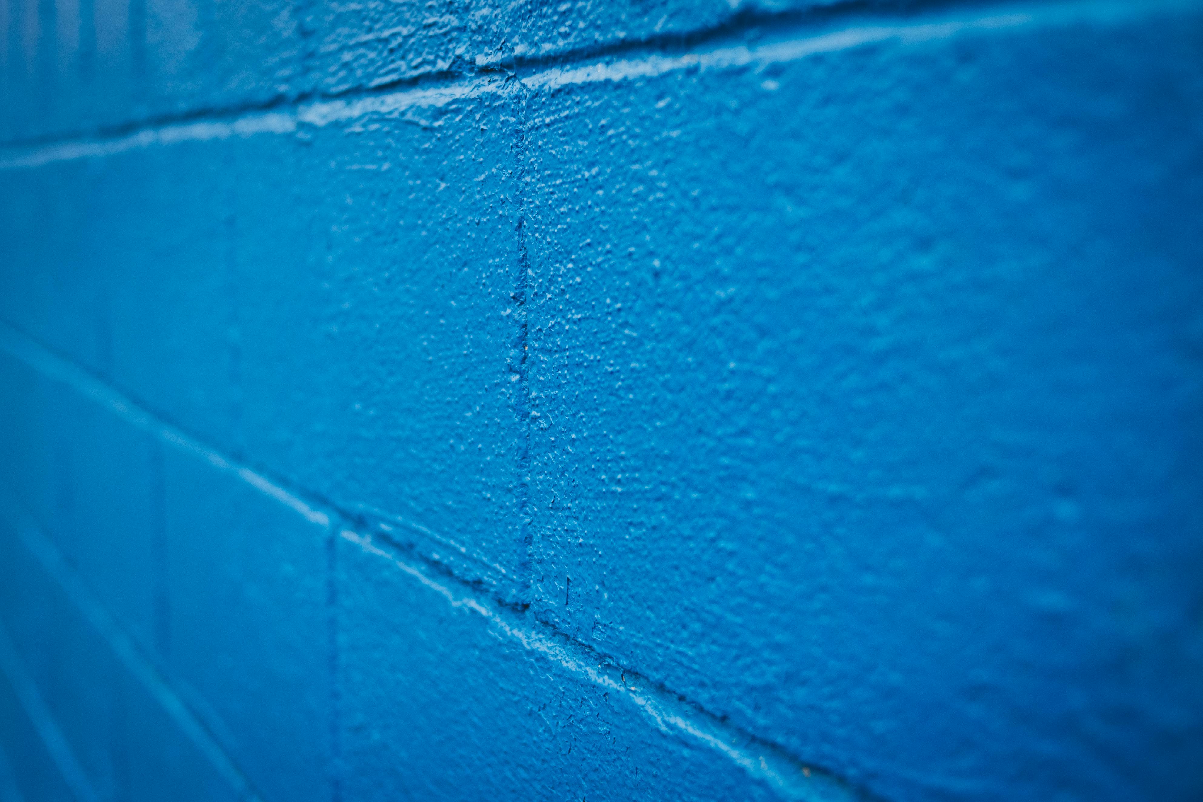Blue brick wall with uneven surface · Free Stock Photo