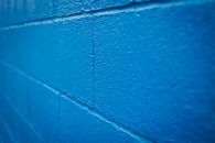 Blue brick wall with uneven surface
