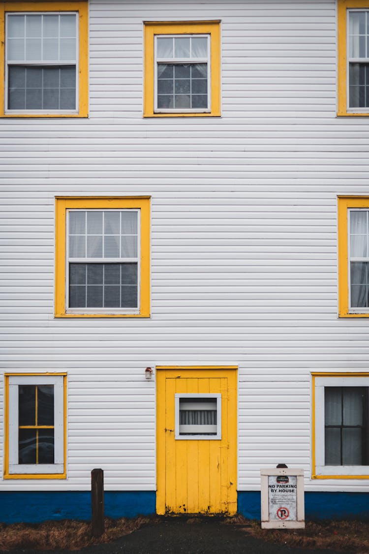 Front Wall Of Building With Door And Yellow Window Frames