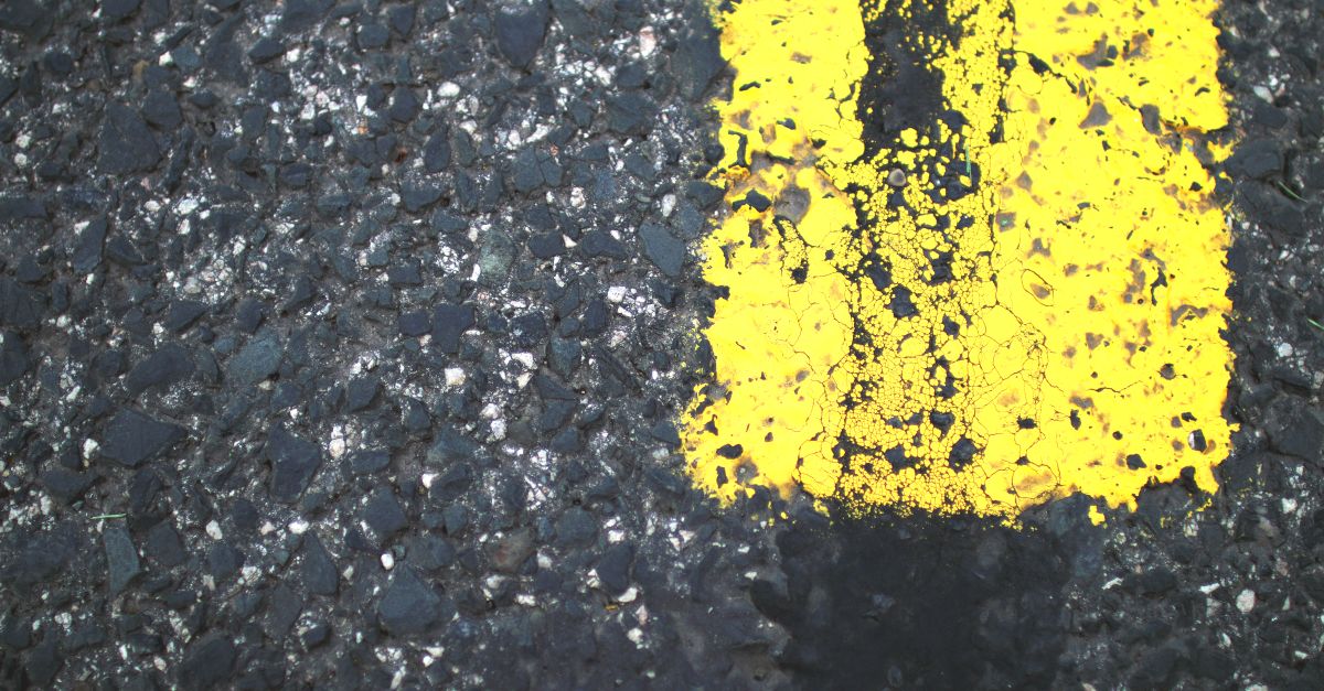 Close-up of road marking paint being applied