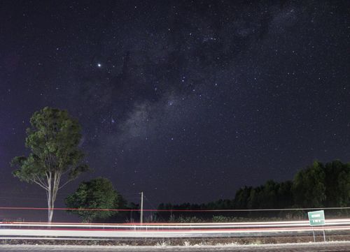 Free Capture of a star-filled night sky in Abadiânia, Brazil, showcasing light trails and natural surroundings. Stock Photo