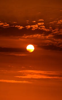 Vivid orange sunset with dramatic clouds in Ica, Peru.
