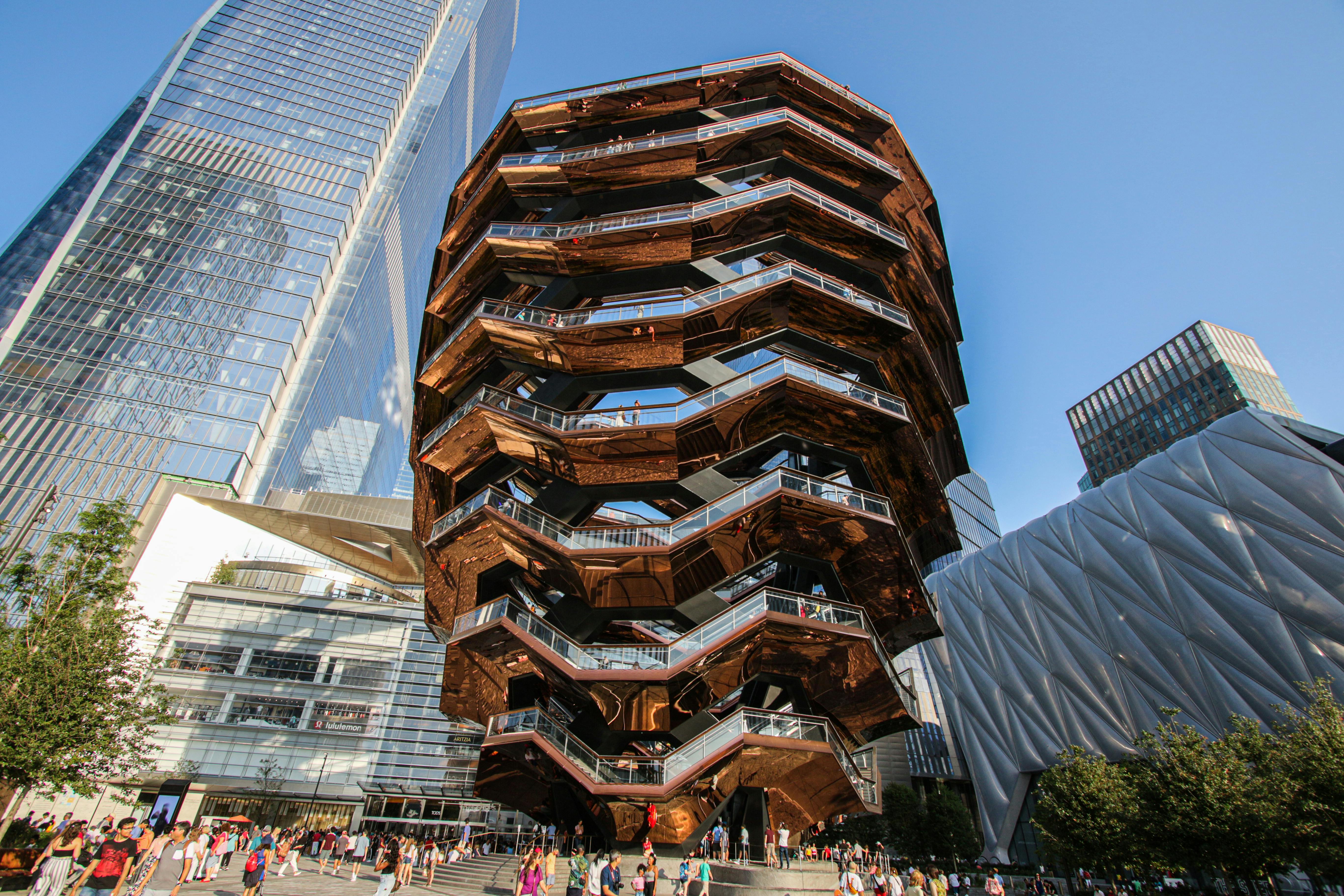 The Vessel and modern skyscrapers in Hudson Yards, a vibrant New York City attraction.