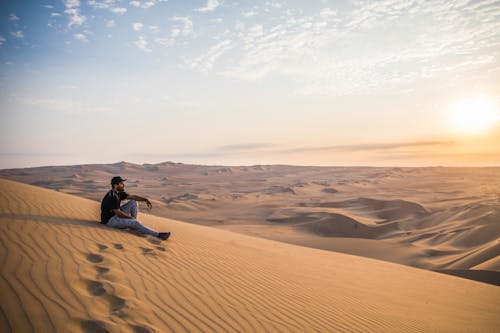 A Man Sitting on the Desert 