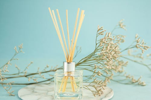 Perfume sticks near natural flowers