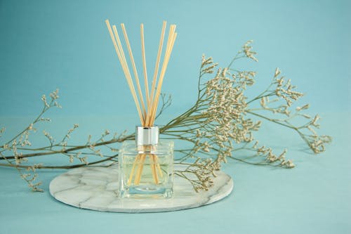 Glass of natural essential oil with sticks