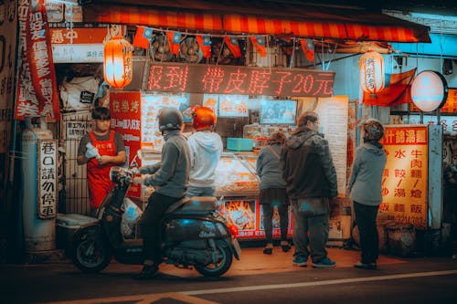 People Standing In Front of Food Stall