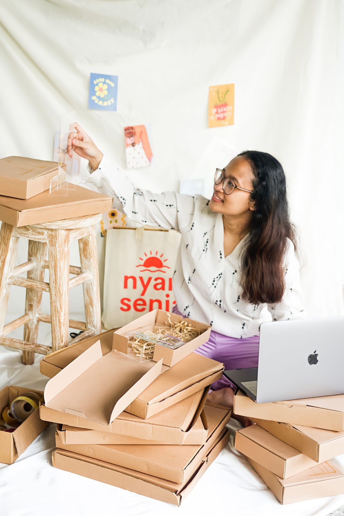 Small business owner packing customer orders at a home workspace