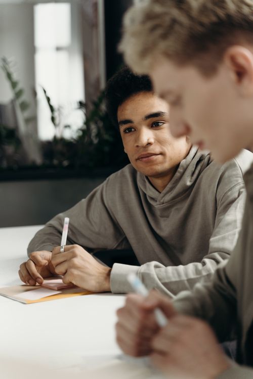 Free Two professionals engaged in a brainstorming session at the office. Stock Photo