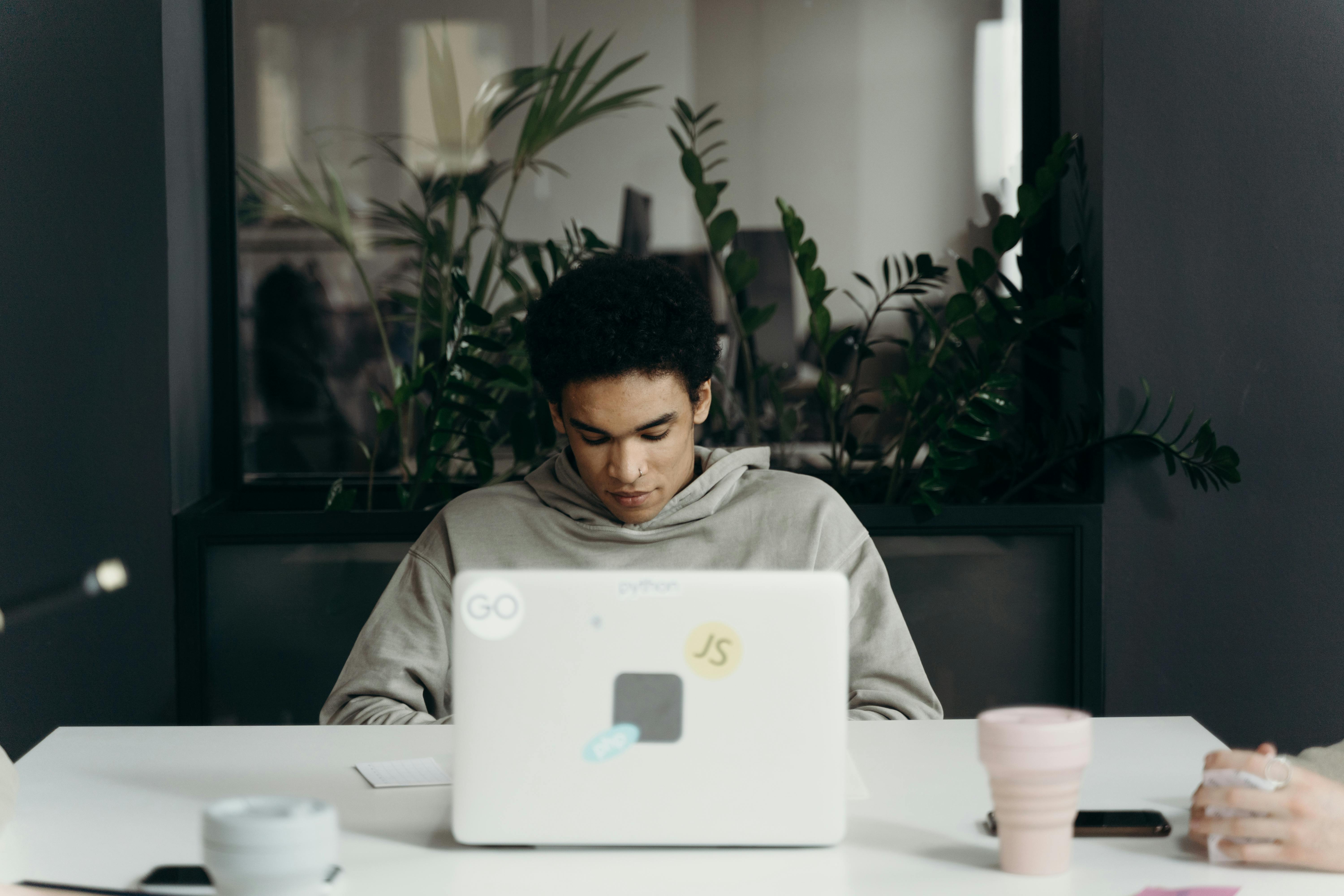 Man sitting in front of a laptop. | Photo: Pexels