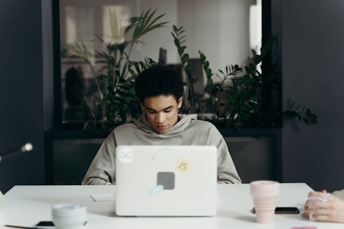 Free Man Sitting In Front of a Laptop Stock Photo