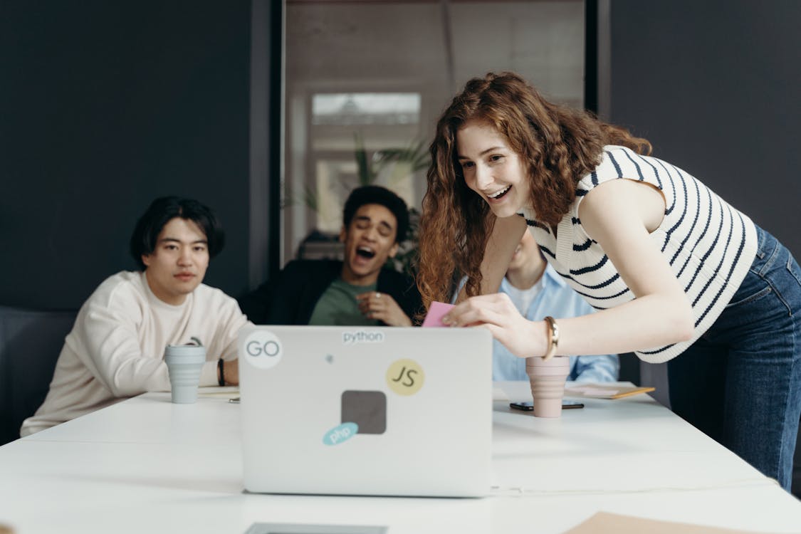 Free People Laughing Looking at a Laptop Stock Photo