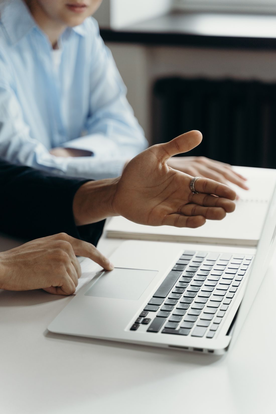 Professionals reviewing work together on a laptop
