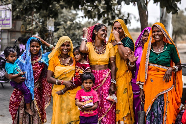 A Group Of Women In Colorful Traditional Dresses