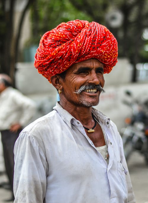 Selective Focus Photo of a Man with a Mustache Wearing a Red Turban