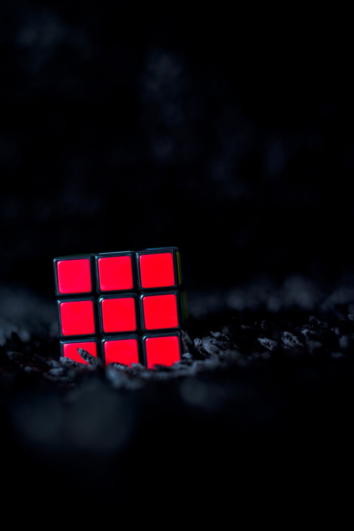 close-up of a colorful 3x3 cube on a dark textured background