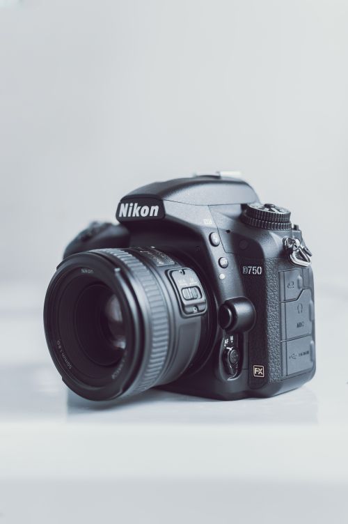 Free Detailed close-up of a Nikon DSLR camera showcasing its intricate design and features. Stock Photo