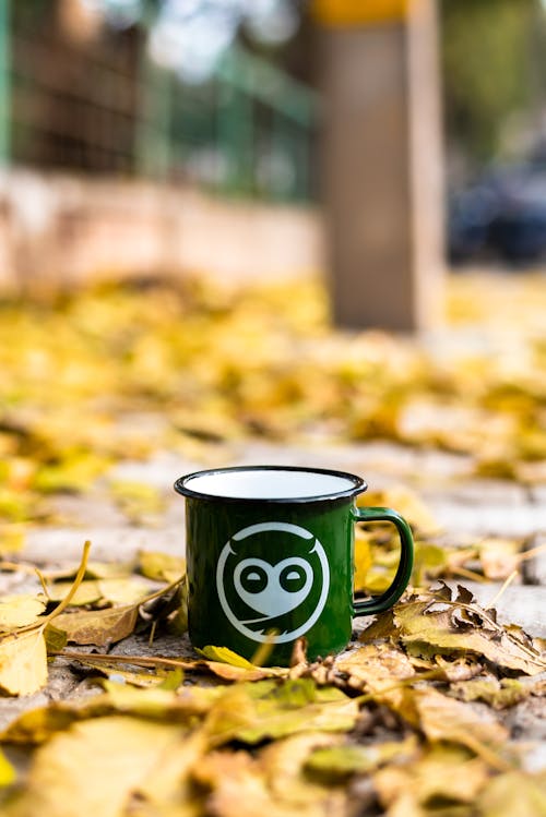 Close-Up Shot of a Green Mug on the Ground