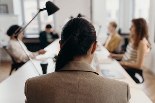 Free Diverse professionals collaborating in a modern office space, focused on teamwork and project management. Stock Photo